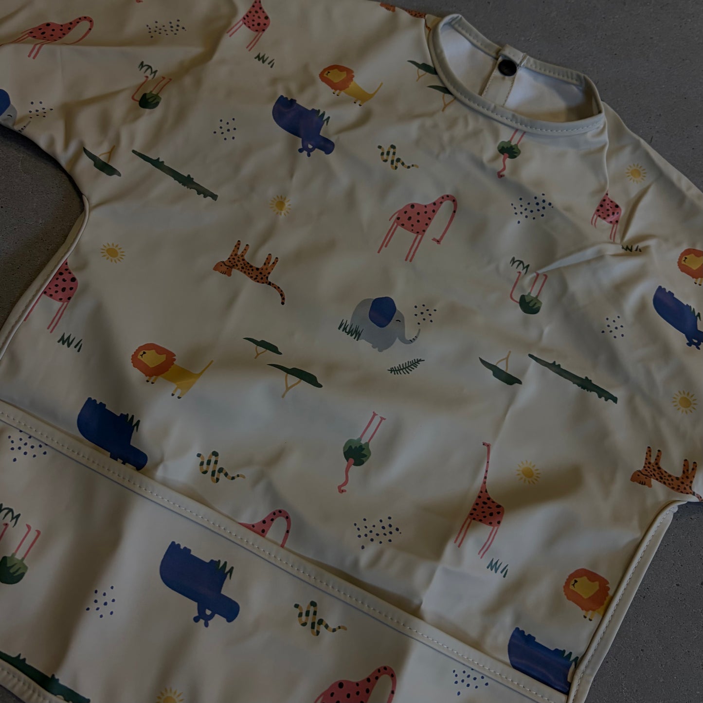 Waterproof slab met mouwen – verstelbaar (0–4 jaar) flamingo
