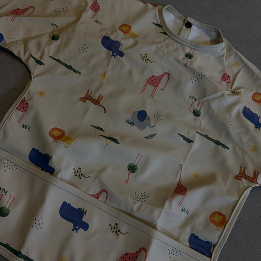 Waterproof slab met mouwen – verstelbaar (0–4 jaar) flamingo