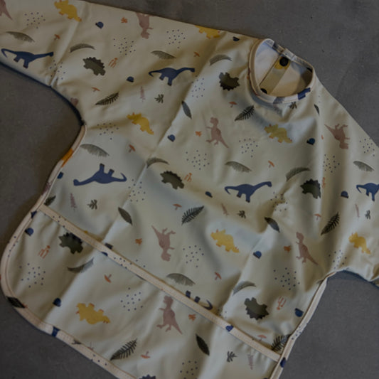 Waterproof slab met mouwen – verstelbaar (0–4 jaar) dino